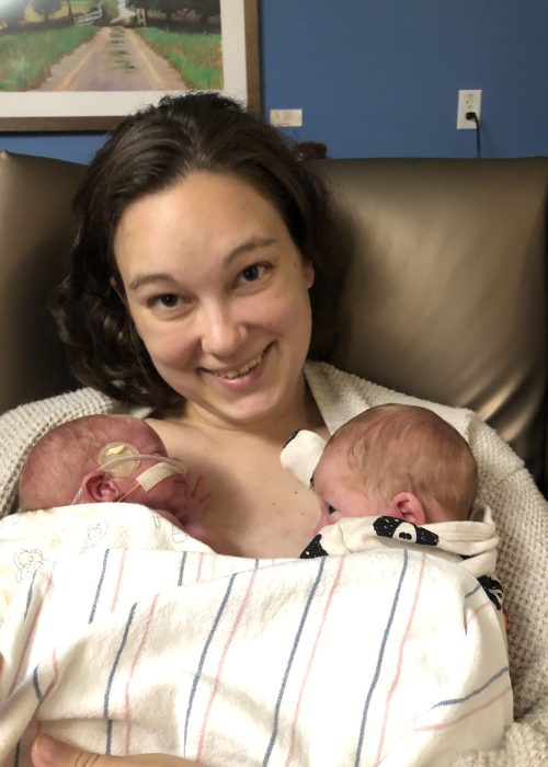 Erin, smiling, with Axel and Barrett in the hospital