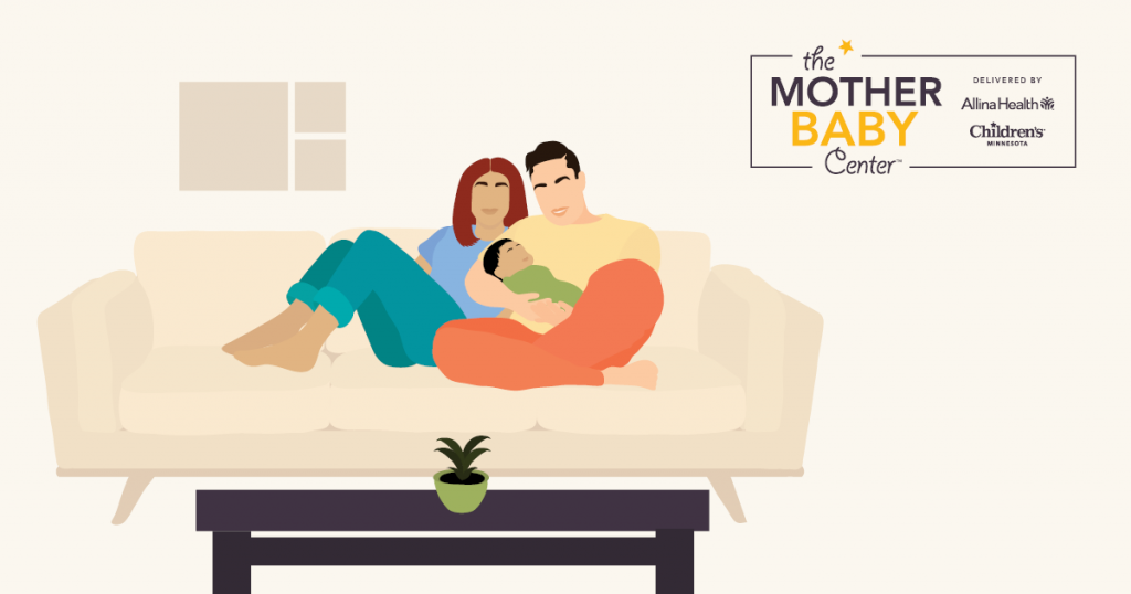 Man and woman on their couch with their new baby